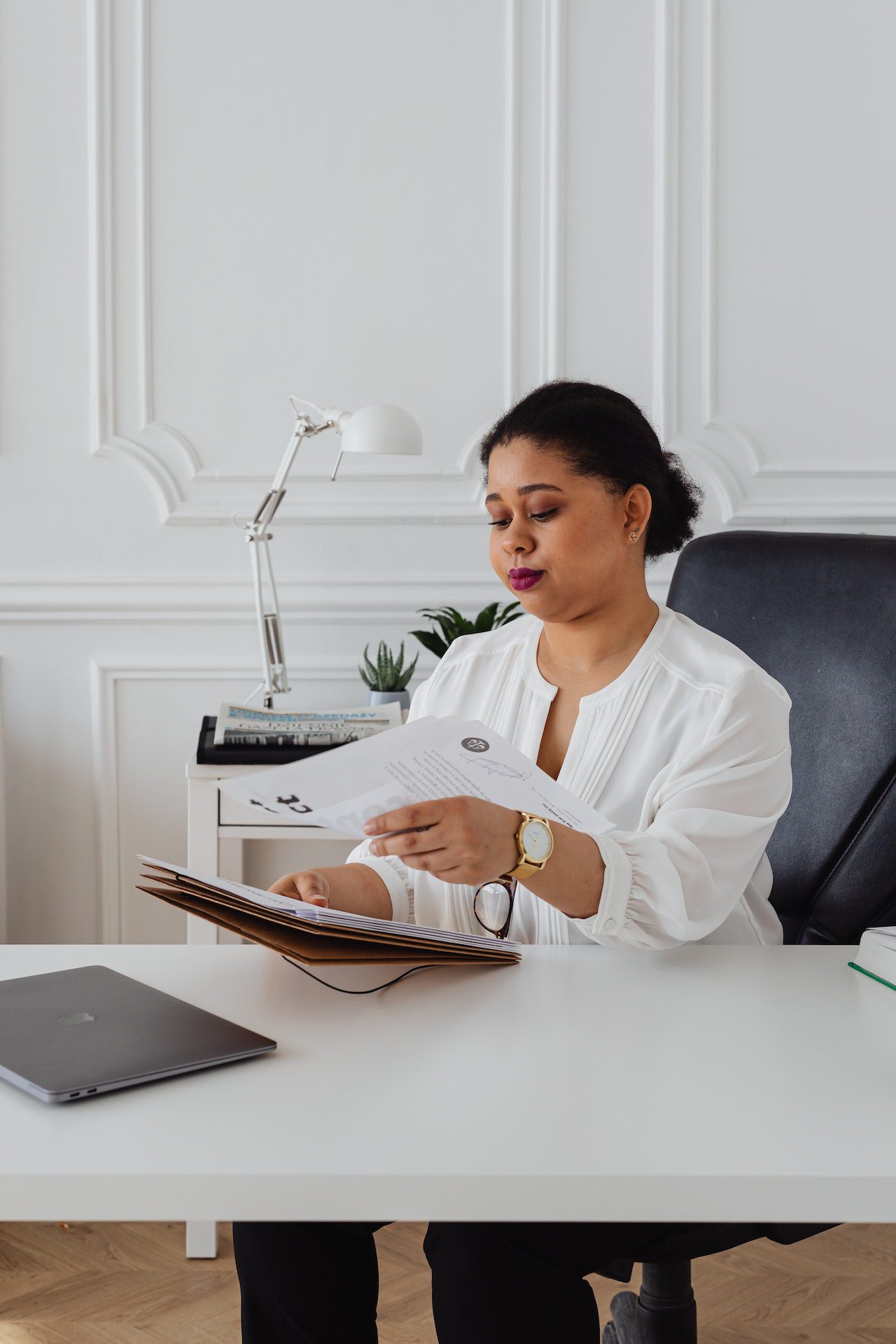 A lawyer sitting at her desk and reviewing documents.